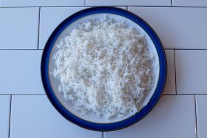 An image of some day-old rice on a plate with a blue rim