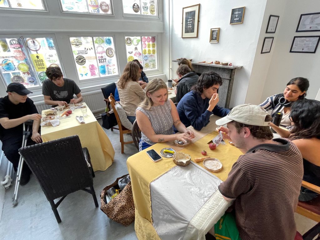 An image of people sitting down to enjoy lunch.