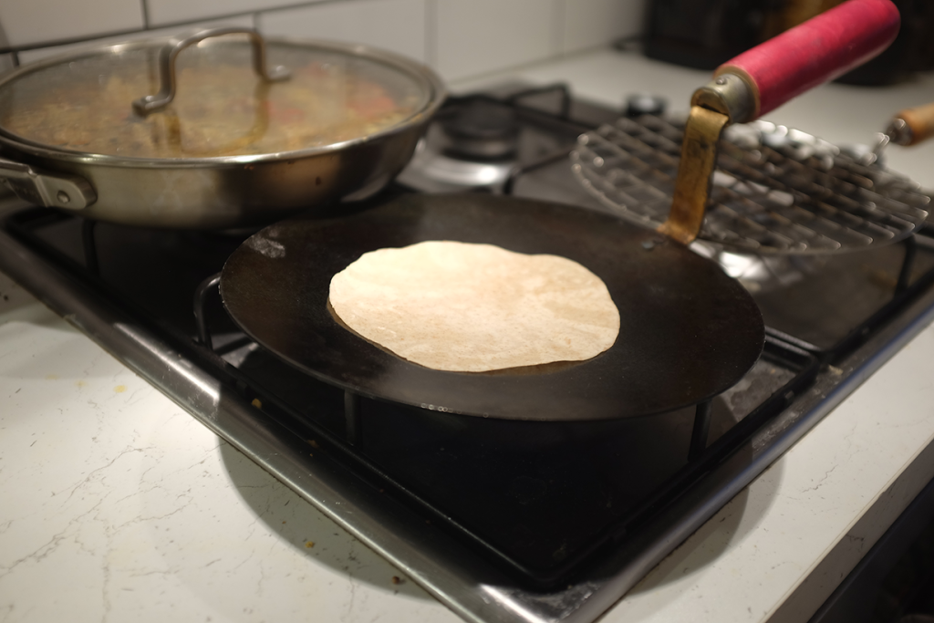 A chapati cooking on a tawa.