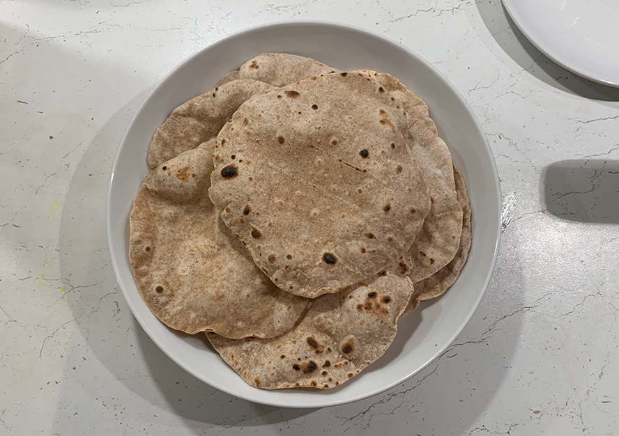 A bowl of chapatis cooked and ready to eat.