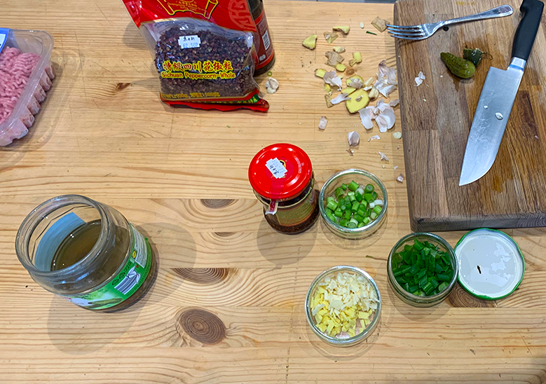 Different ingredients being prepared on a chopping board.