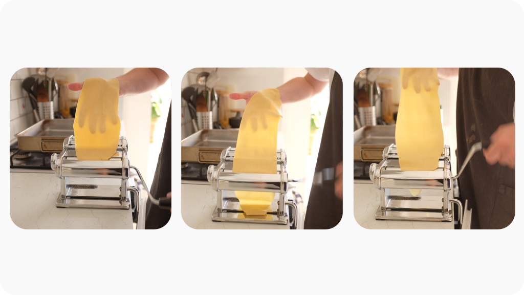 Pasta dough being rolled through a pasta roller.