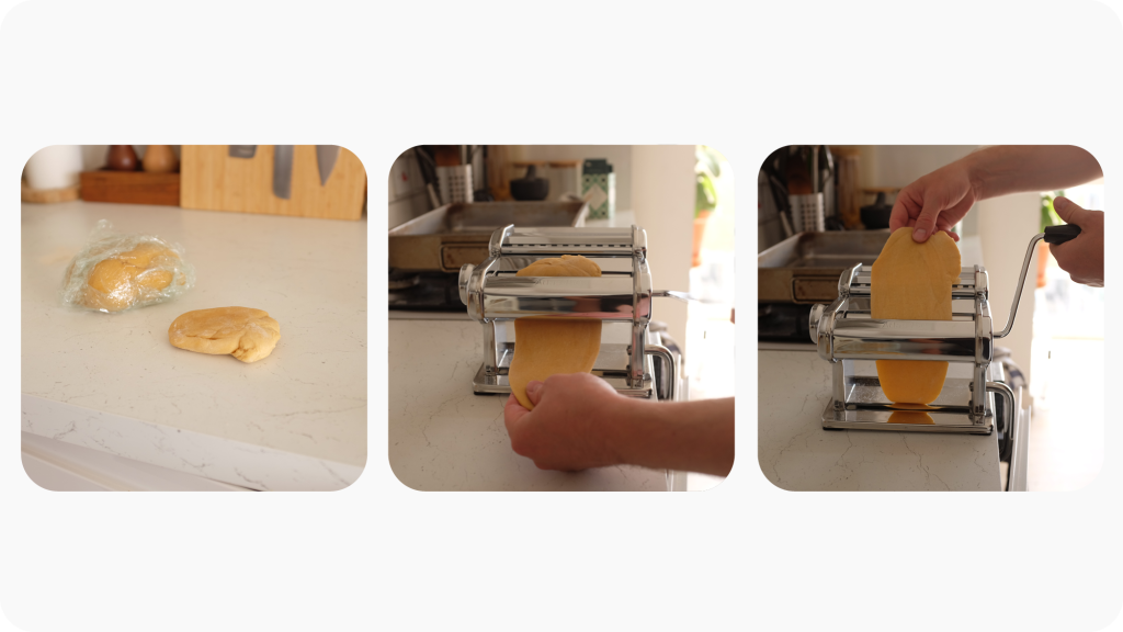 Pasta dough being rolled through a pasta roller.