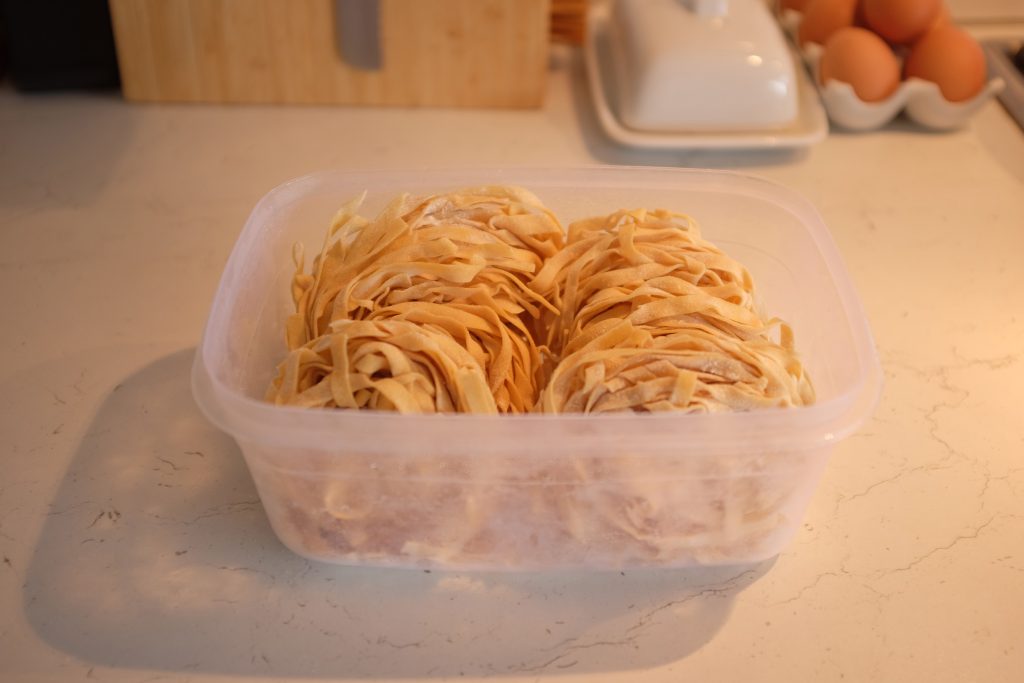 A Tupperware full of frozen nests of tagliatelle.