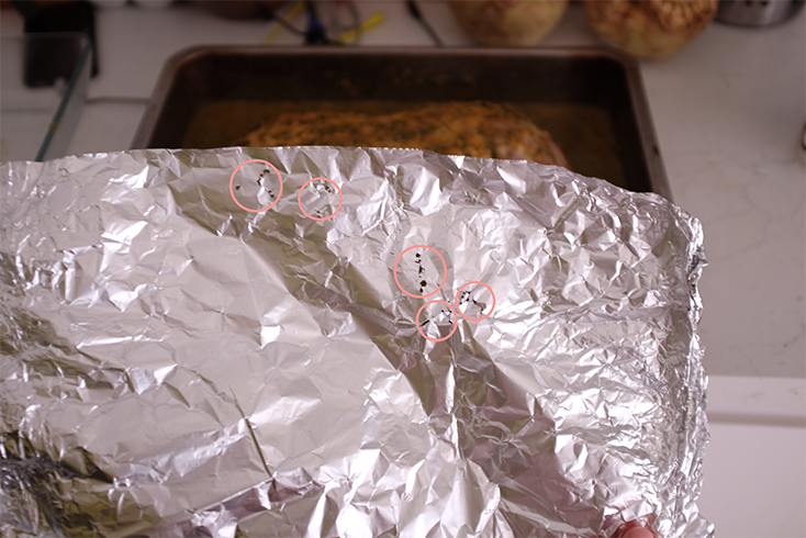 An image of holes burned through aluminium foil.